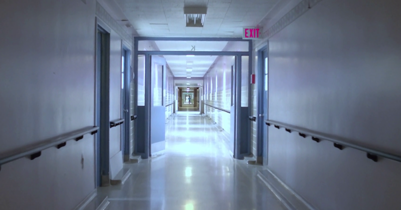 pan down to roll down hospital hallway empty white walls bgetwtyzl thumbnail full08 e1571769345577